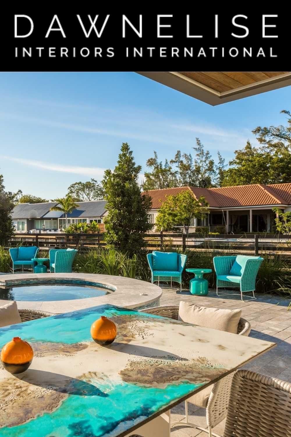 An outdoor living room featuring the Etna dining table from Seasonal Living by DawnElise Hamilton